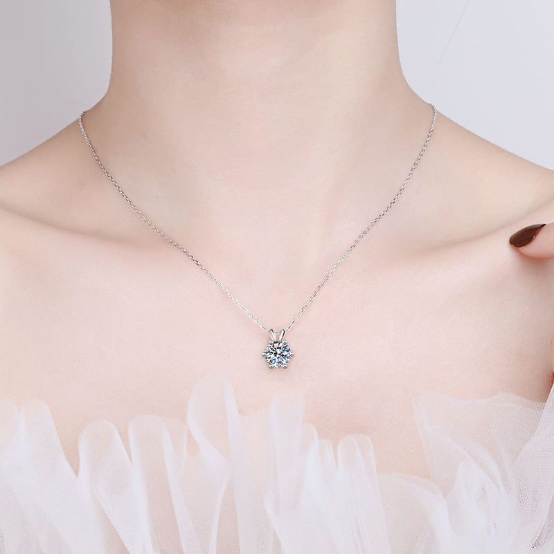 The 6.5 mm moissanite pendant worn at the collarbone on its 40 cm chain